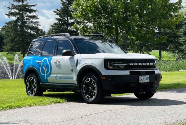 A custom partial wrap on a Ford Bronco Sport in white and blue, enhancing Park View Homes’ fleet branding in Ottawa.