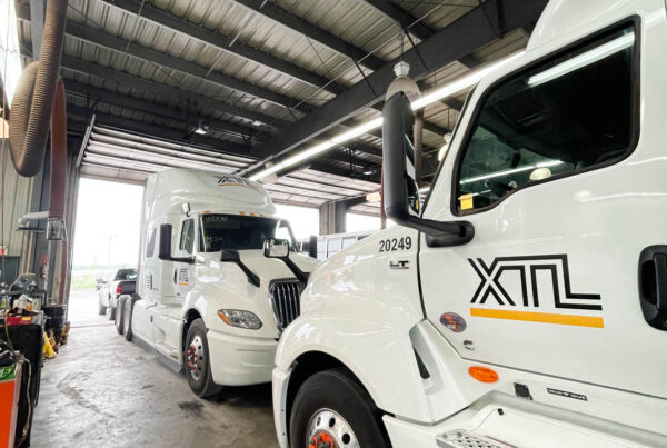 A lineup of custom commercial truck wraps for XTL Transport in Ottawa, ensuring strong visibility on highways and job sites.