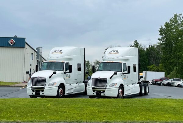 A lineup of custom commercial truck wraps for XTL Transport in Ottawa, ensuring strong visibility on highways and job sites.